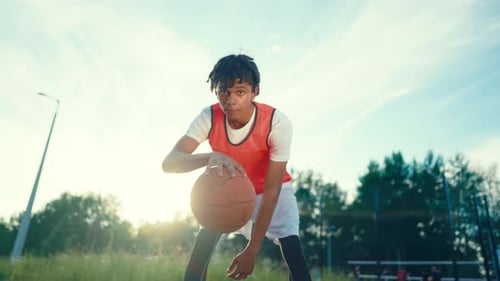Young Black Basketball Player Training on Outdoor Court Junior Streetballer Sportsman Practicing on