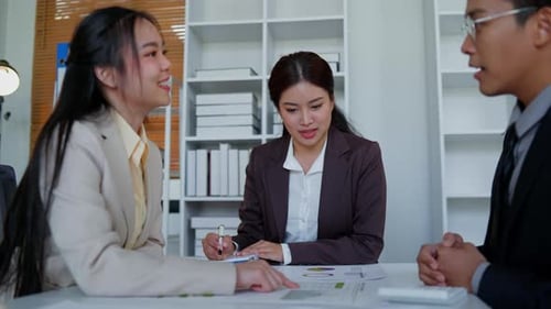 Business Team Discussing Graphs in Modern Office