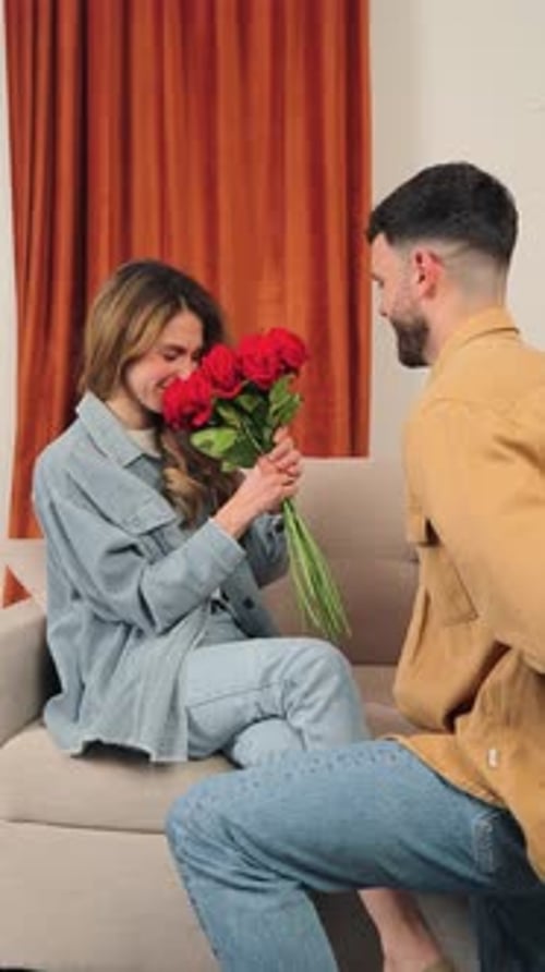 Romantic Proposal: Man Giving Red Roses and Engagement Ring