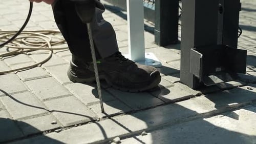 Builder Drills a hole in the wall with a Hammer Drill. Close-up of hammer drill perforator making ho