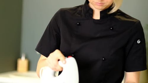 Woman Chef Mixing Food in Kitchen