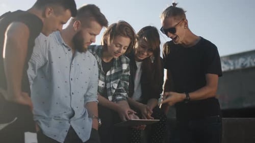 Group of Friends Gather Around Tablet in City