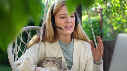 Woman With Cat Working Outdoors on Laptop