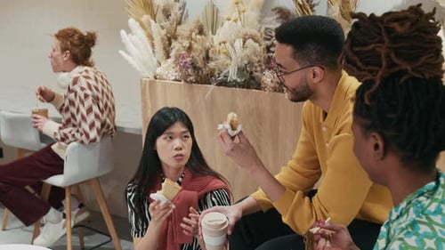 Friends Eating and Talking Together in a Cafe