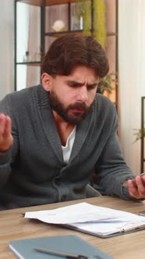 Un indio revisa documentos con líneas de rastreo de teléfonos inteligentes y encuentra errores, cargos adicionales con tarjetas bancarias enojados