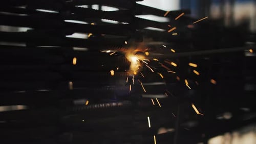 Welding Metal Bars Together in Dark Setting