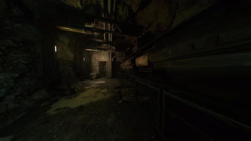 Faint Light Reveals Derelict Factory Passage with Scattered Remnants and Shadows