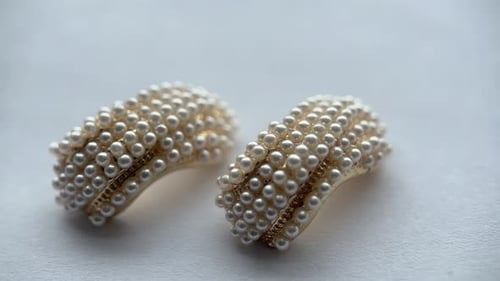 Close Up of Pearl Earrings on White Surface