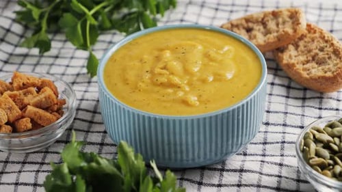 Creamy Vegetable Soup with Bread Seed Pumpkin Herbs Rusks Table Served with Homemade Food