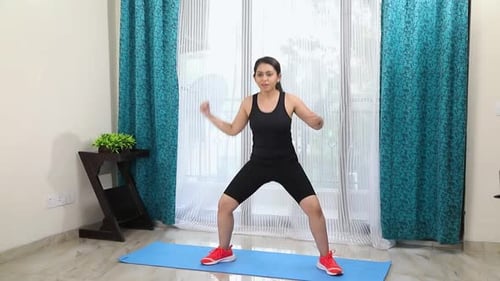 Young Woman Doing Bodyweight Sumo Squats at Home
