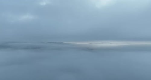Aerial View of Fog-Filled Valley on Overcast Day