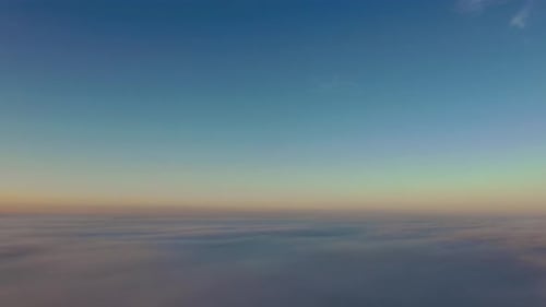 Mesmerizing cloudscape aerial drone view at sunrise, sunset giving a golden yellow color to the clou
