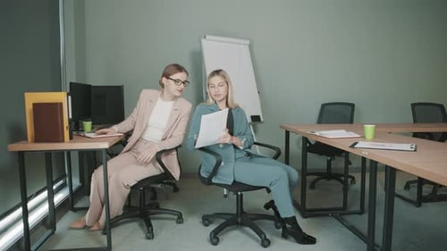 Team brainstorming session with women discussing business plans in a modern office setting