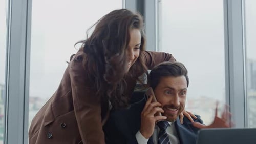 Two Office Colleagues Celebrating Business Success Working in Cabinet Close Up