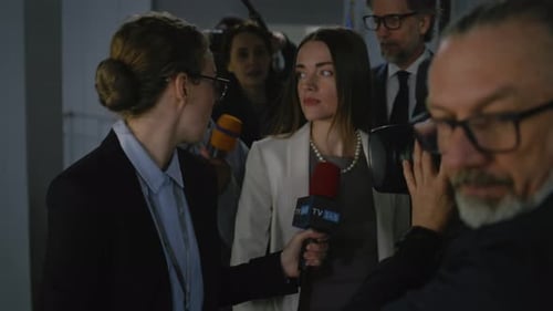 Woman Giving Interview Surrounded by Press