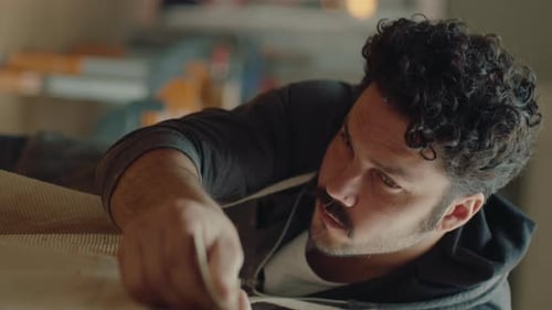 Man Smoothing Wood with Tool in Workshop Close-Up