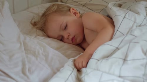 Peaceful Adorable Baby Sleeping on a Bed at Home Slumbering Little Child Two Years Old Girl Sleeps