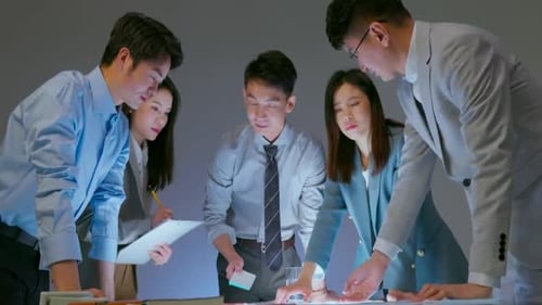 Creative Work. Concentrated Colleagues Work Together Discuss Business Idea. Young Asian Financial Co