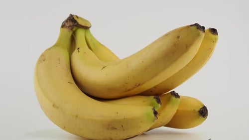 Bunch of Yellow Bananas Rotating on White Background