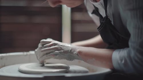 Potter Shaping Clay on a Pottery Wheel