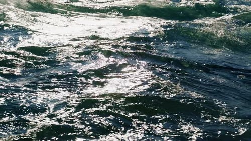 Experience the Mesmerizing Beauty of Glittering Ocean Waves Shimmering Under the Warm Sunlight