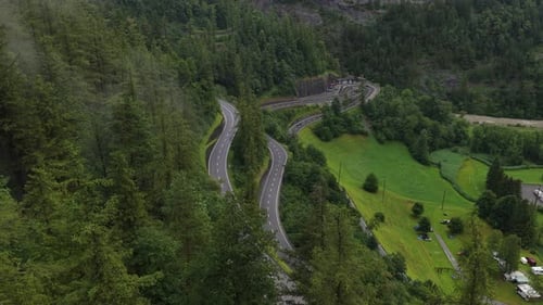 Winding Mountain Road Descending Into Lush Valley