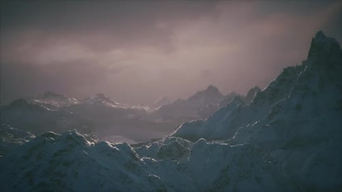 Dramatic Pan Across Snowy Mountain Range Landscape