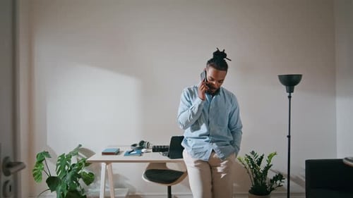 Focused Guy Talking Mobile Home Office. Smart Professional Speaking Cellphone at Workplace