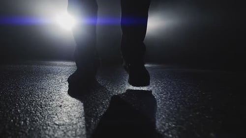 One Person Walking Alone on Street in Dark Night