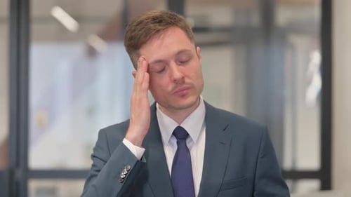 Man in Suit Experiencing Headache at Work