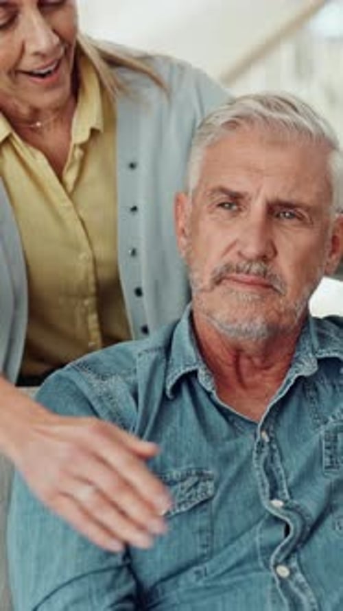 Senior Woman Embracing Gray-Haired Man in Denim Shirt