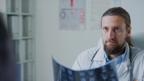 Focused Doctor Examining Brain Scan in Office