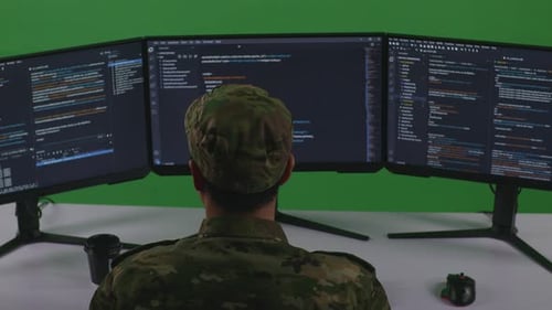 Asian Man Soldier Developer Using Computer To Write Code With Multiple Screens In Green Screen