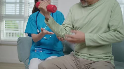 Healthcare Worker Assisting Senior Man with Arm Exercise