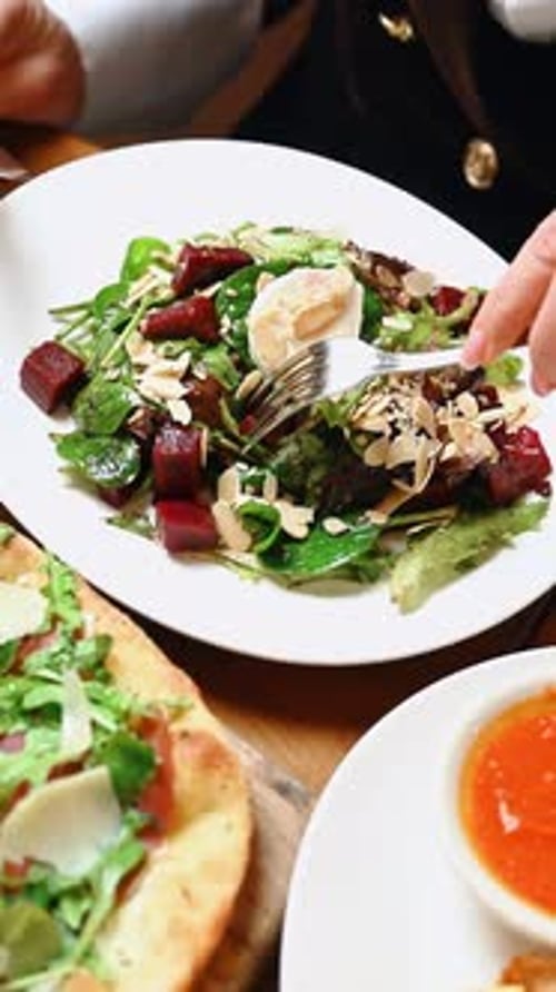 Woman enjoys a salad with beets and egg