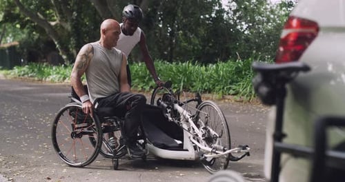 Wheelchair, sports and men help on handbike in park for training, cardio workout and exercise