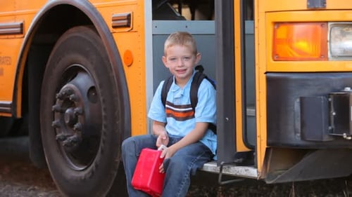 Young Boy Walks to Front of School Bus 6-7