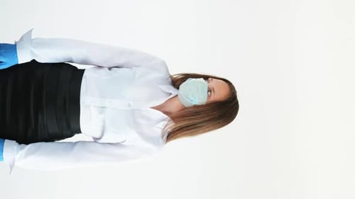 Woman With Mask and Gloves Gives Thumbs Down