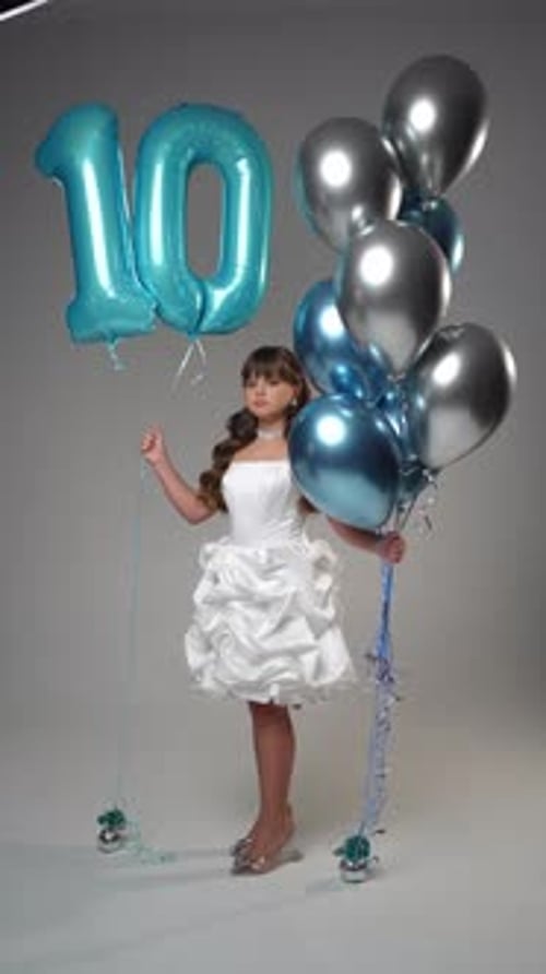 Girl Celebrating Tenth Birthday with Balloons