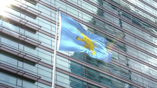 Blue Flag with Golden Lion Waving in Front of Corporate Building