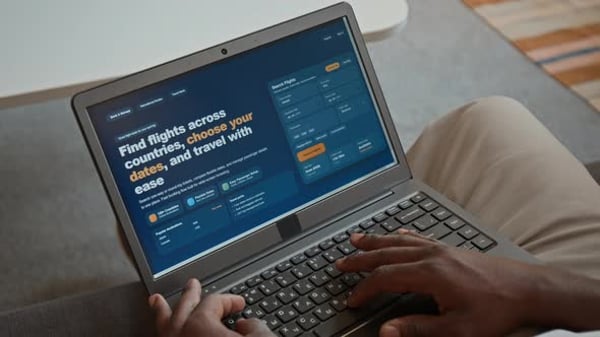 Laptop Displaying Travel Booking Website in a Bright Home Setting ...