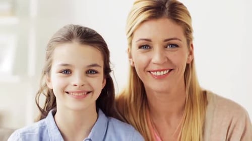Happy Girl with Blonde Haired Woman Smiling Indoors