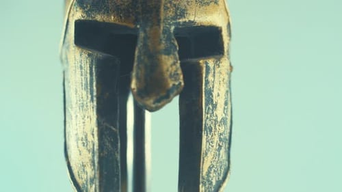 A rotating close up macro shot of a spartan warrior metal bronze ancient greek helmet, studio lighti