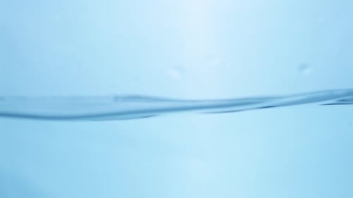 Abstract Close-Up of Water Flowing with Splash, Ripples, and Bubbles. Fresh, Transparent, and Smooth