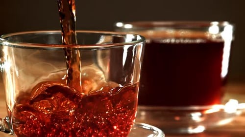 Hot Tea Being Poured into Cup