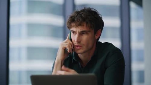 Young Adult Talking on Phone in Office Setting