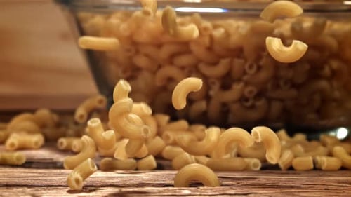 Dry Pasta Falls on a Wooden Table Filmed on a Highspeed Camera at 1000 Fps