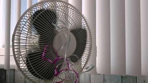 Rotating Electric Fan with Pink and Grey Ribbons
