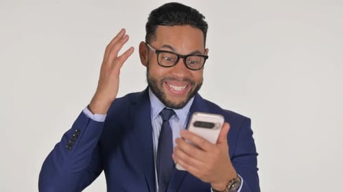 Man Reacts Happily to News on Mobile Phone