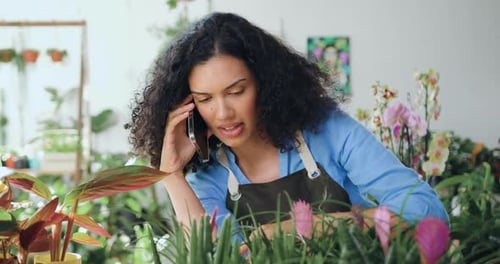 Woman Talking on Phone While Working at Plant Shop